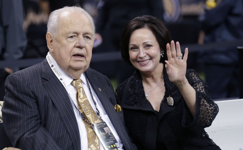 New Orleans Saints owner Tom Benson sits on the sideline with wife Gayle Benson before a game against the Green Bay Packers in October.
