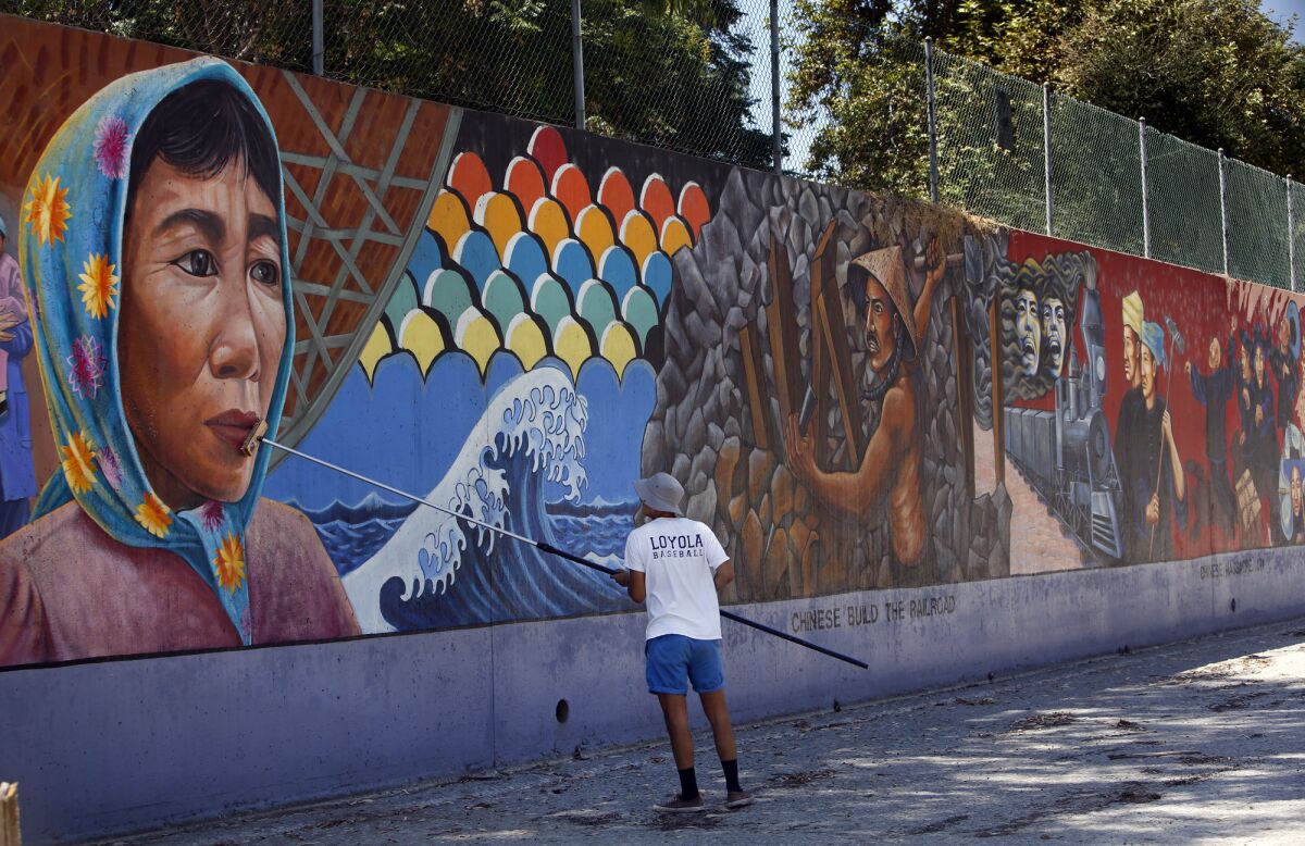A representative from the Social and Public Art Research Center, or SPARC, cleans Judith Baca's "The Great Wall of Los Angeles" in 2014. Baca is the first muralist to win one of United States Artists' $50,000 awards.