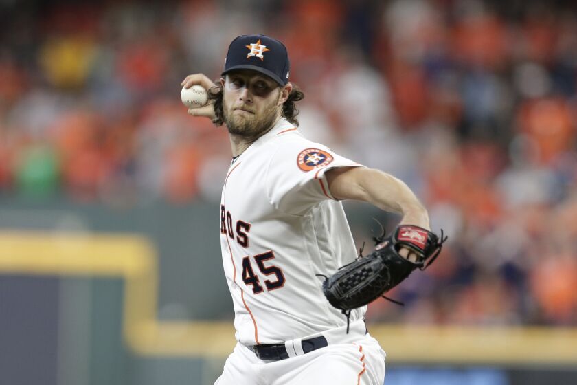 Houston Astros starting pitcher Gerrit Cole (45) pitches against the Tampa Bay Rays during the first inning of Game 5 of a baseball American League Division Series in Houston, Thursday, Oct. 10, 2019. (AP Photo/Michael Wyke)