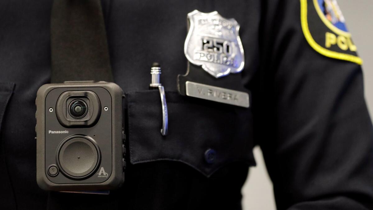 A police officer displays how a body cam is worn during a news conference in Newark, N.J. on April 26.