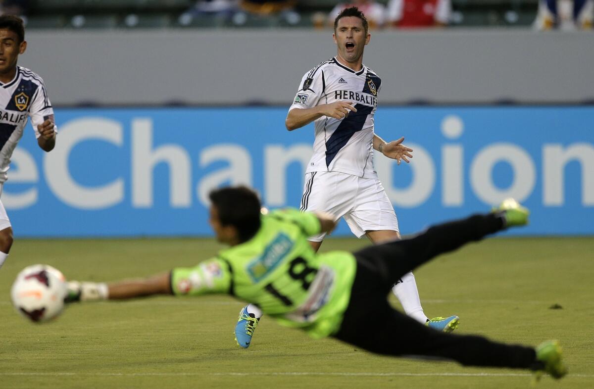 Galaxy forward Robbie Keane, top, reacts after Cartagines goalie Wardy Alfaro blocks his shot during the first half of the Galaxy's 2-0 win Tuesday.