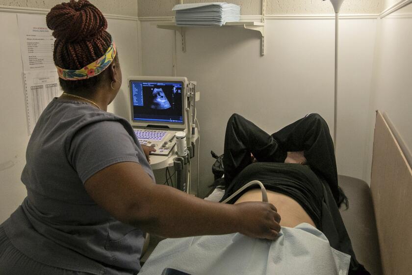 FILE - An operating room technician performs an ultrasound on a patient at Hope Medical Group for Women in Shreveport, La., Wednesday, July 6, 2022. Abortion clinics in Louisiana can continue operating until a lawsuit challenging the state’s near total ban on abortions is resolved, a state judge ruled Thursday, July 21, 2022. (AP Photo/Ted Jackson, File)