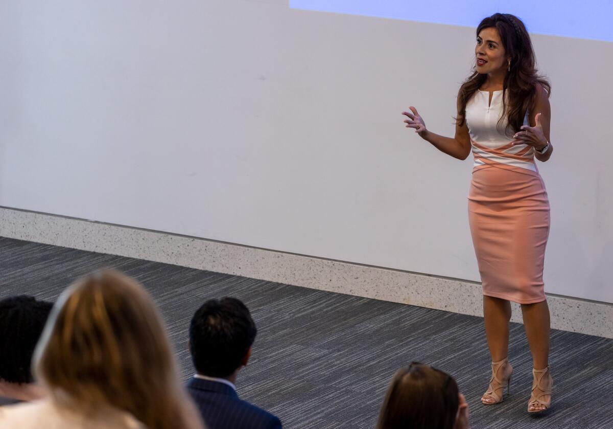 Angelica Gutierrez Ph.D., associate professor of management and leadership, speaks to community members.