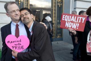 John Lewis, left, and Stuart Gaffney embrace outside San Francisco's City Hall shortly before the U.S. Supreme Court ruling cleared the way for same-sex marriage in California on Wednesday, June 26, 2013. (AP Photo/Noah Berger)