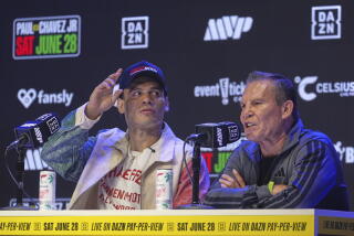 Boxers Julio César Chávez, right, and his son Julio César Chávez Jr., during a news conference in Los Angeles in May.