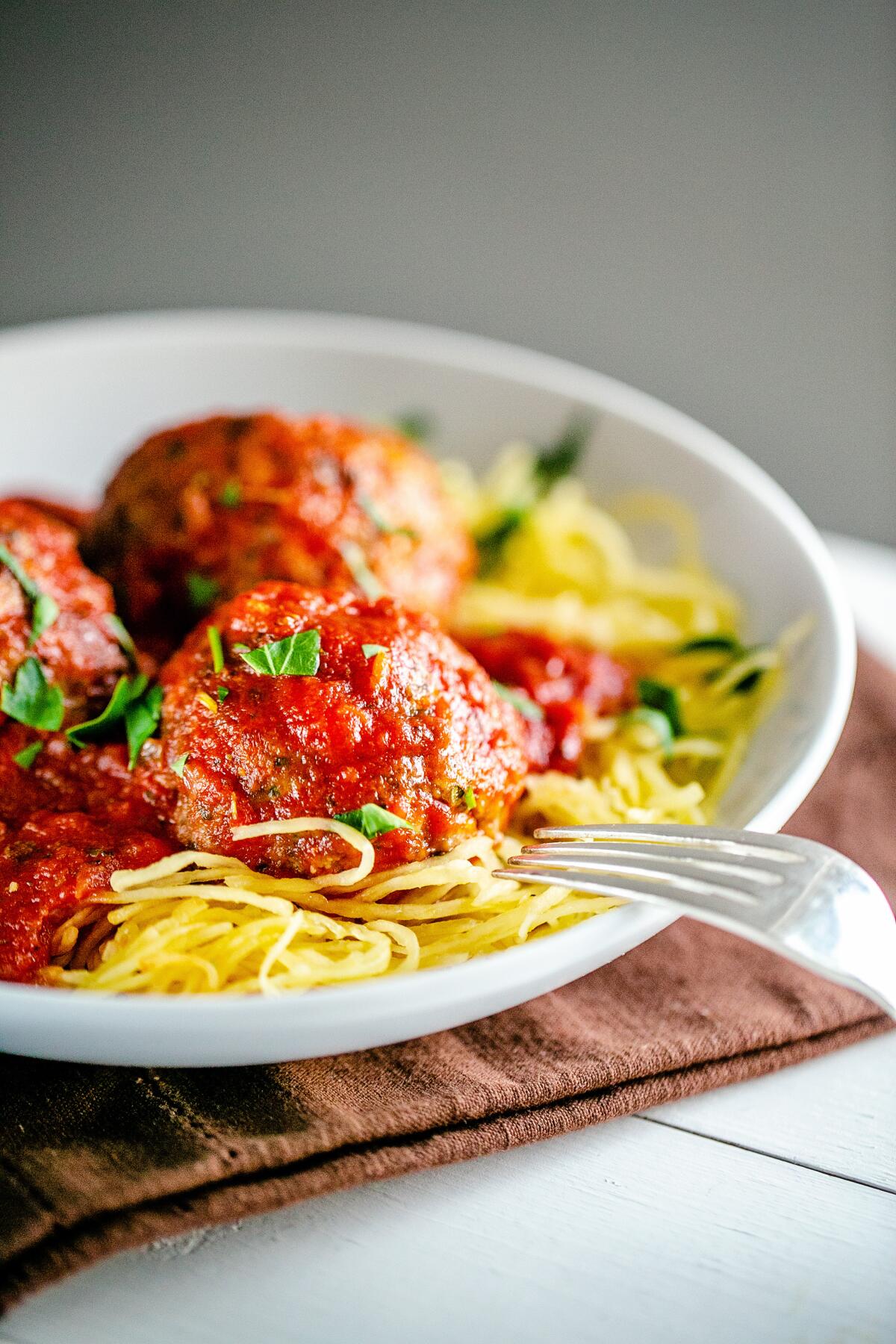 Meatballs and sauce over spaghetti squash.
