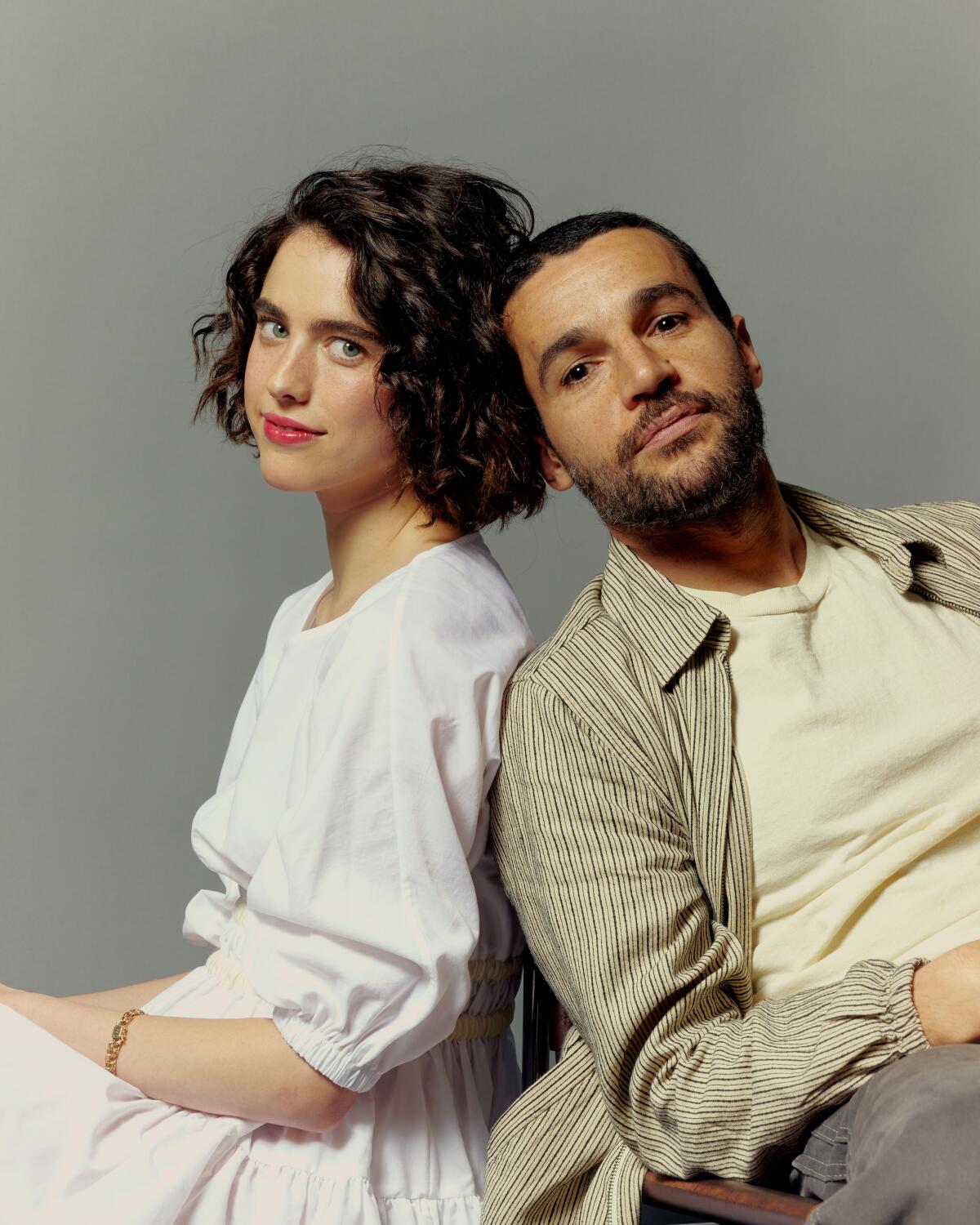 Actors Margaret Qualley and Christopher Abbott pose for a portrait, leaning against each other.
