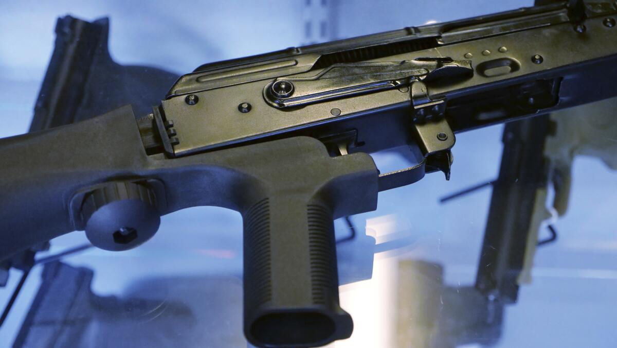 A bump stock device is attached to a semiautomatic rifle at the Gun Vault store and shooting range in South Jordan, Utah.