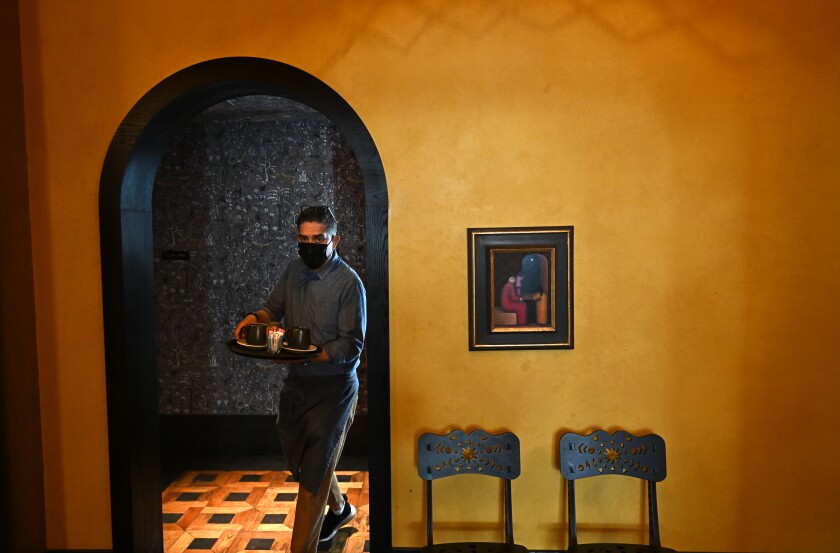 A waiter walks out of the kitchen at the Downtown L.A. Proper Hotel.