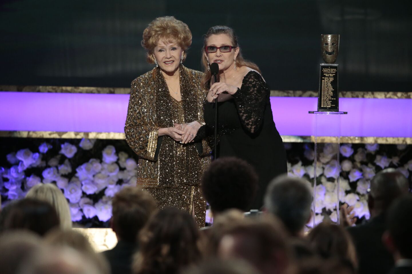 Carrie Fisher presents her mother, Debbie Reynolds, the Life Achievement Award at the 21st Screen Actors Guild Awards at the Shrine Auditorium in Los Angeles on Jan. 25, 2015.