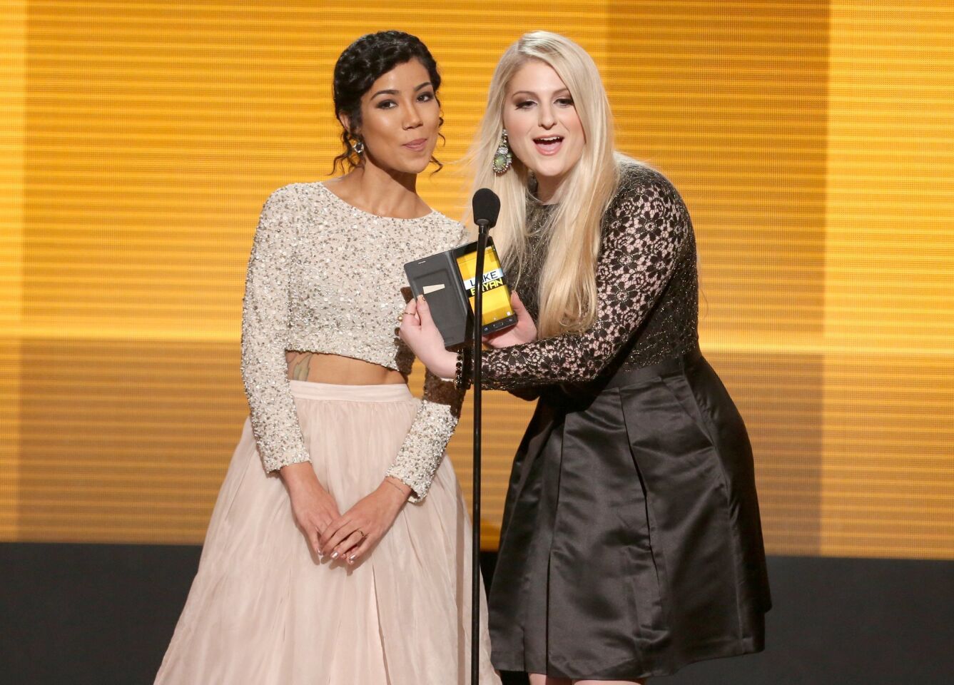 Jhene Aiko, left, and Meghan Trainor present the award for Favorite Country Male Artist.