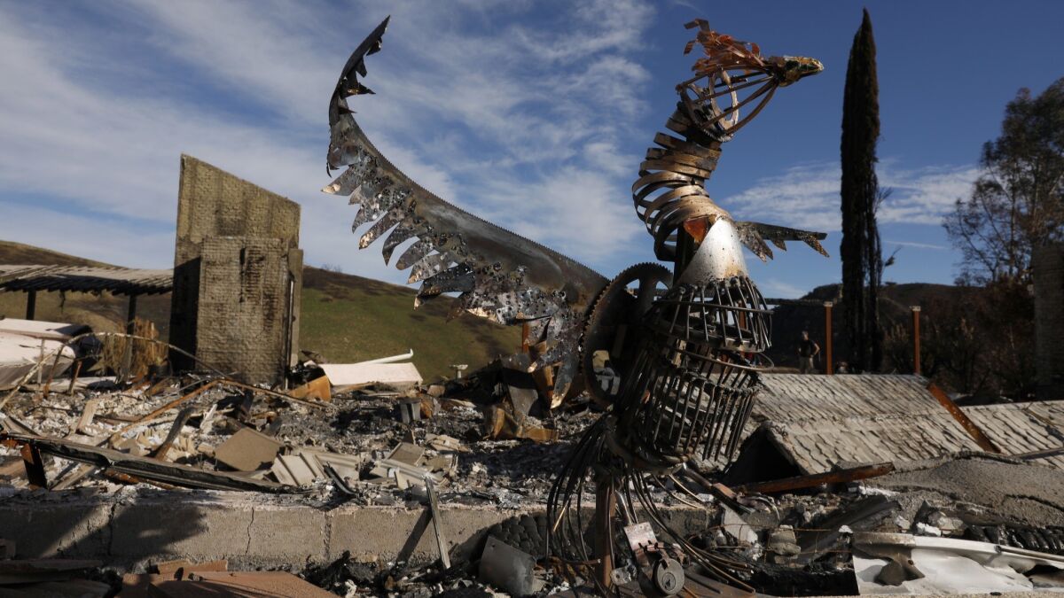 A sculpture of a phoenix created by artist Jessica Bierschenk, 17, of Pacific Palisades stands at her grandmothers burned home in Bell Canyon. Letty Bierschenks home burned down in the Woolsey fire.