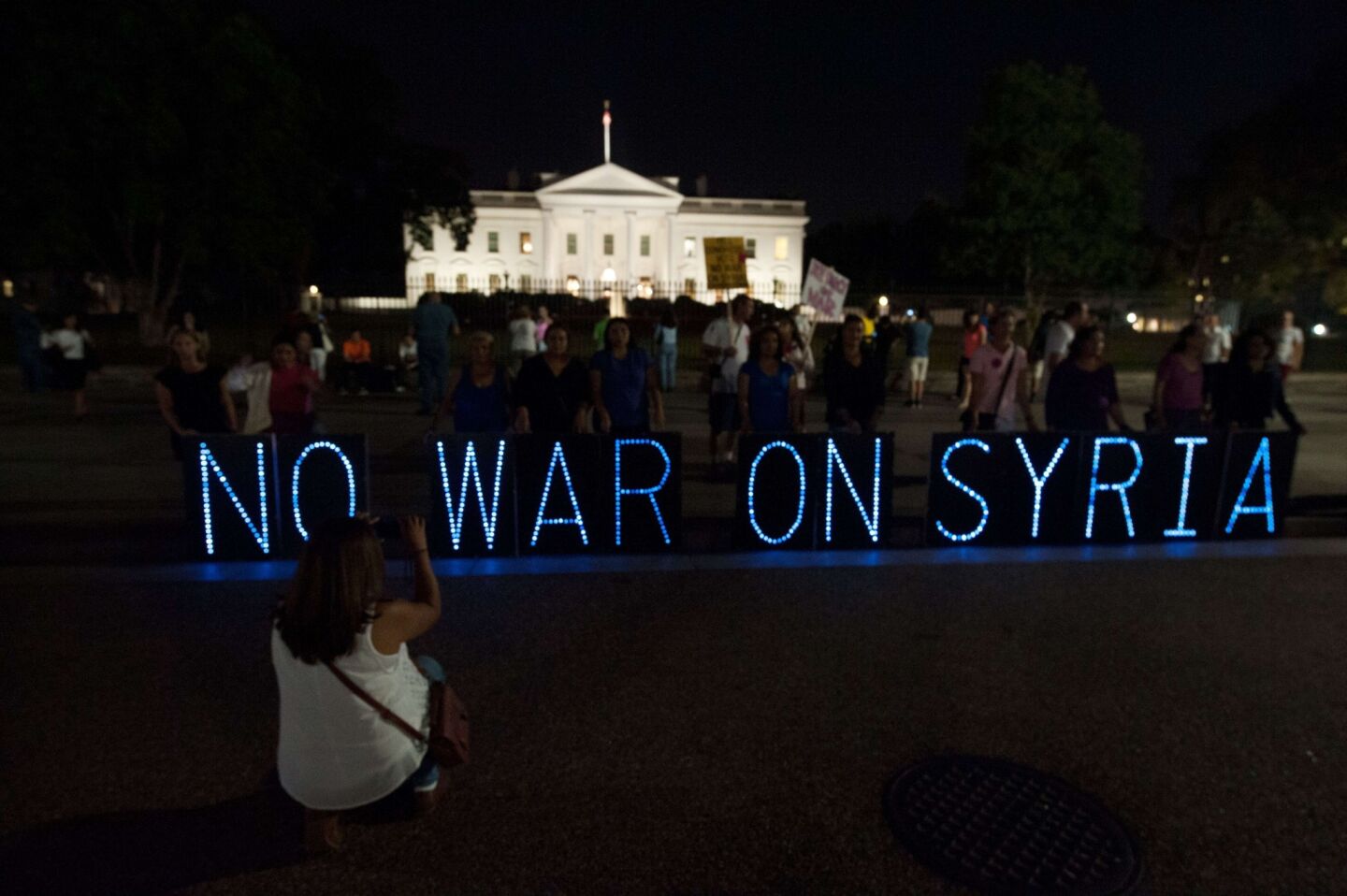 Anti-war demonstrators protest against U.S. intervention in Syria in front of the White House.