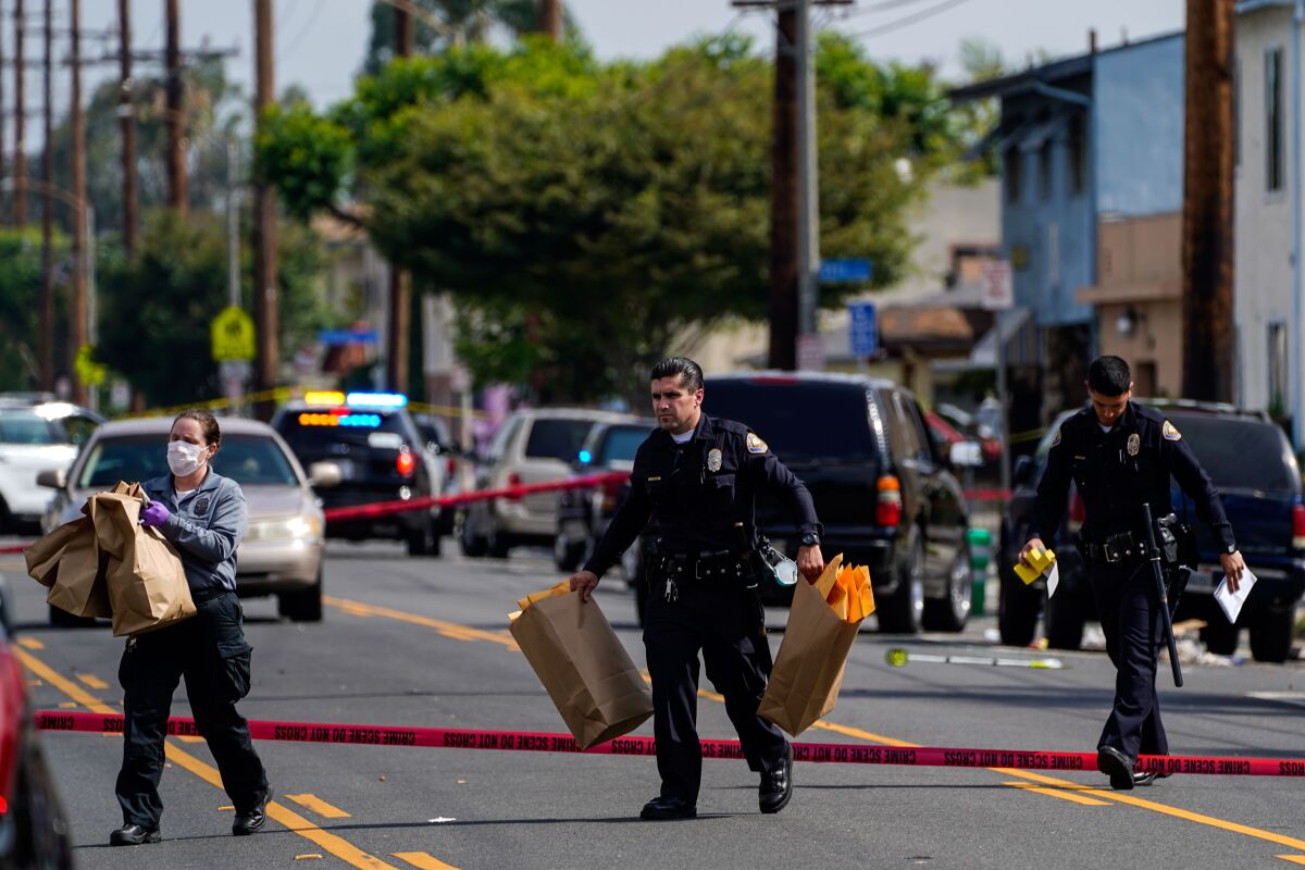 Law enforcement officers at scene of a shooting at the 5800 block of Orange Avenue in Long Beach.