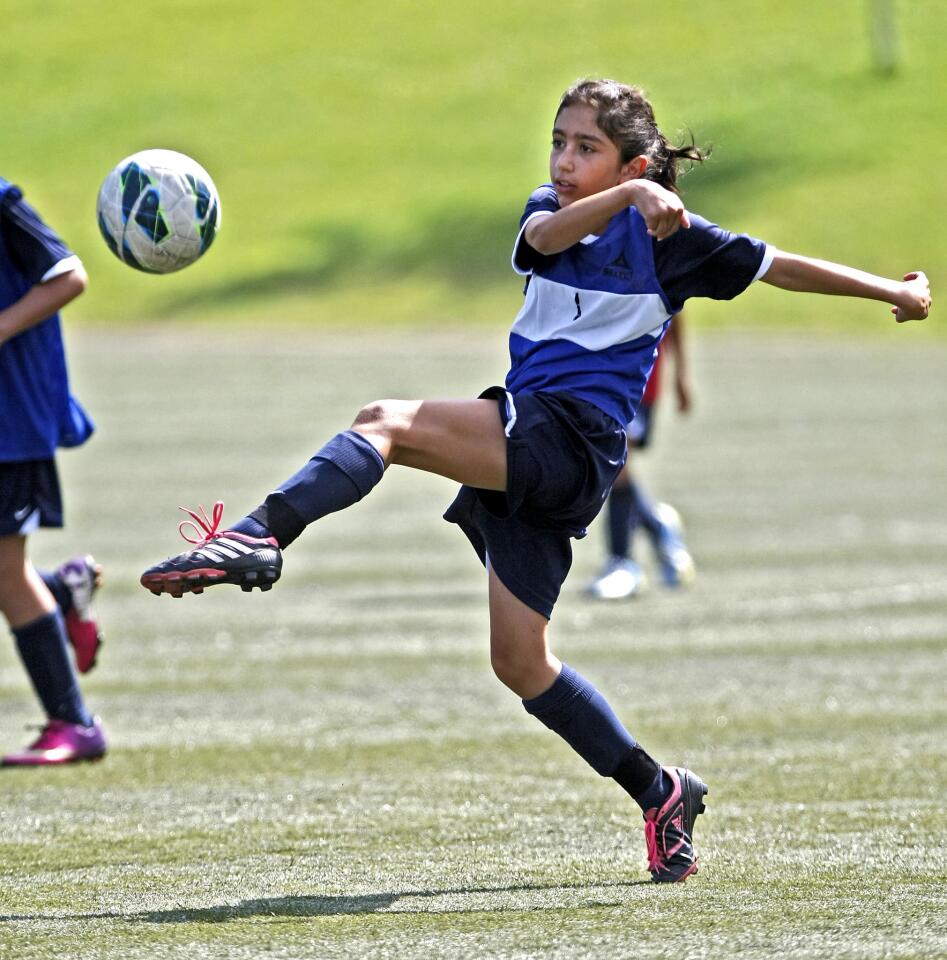 Arpa Dilanchian, 10 of La Crescenta, kicks the ball during scrimmage at the 2013 FC Barcelona Soccer Camp at the Glendale Sports Complex in Glendale on Friday, August 2, 2013. The 5-day camp was run by members of the FCBEscola from Spain along with local coaches.