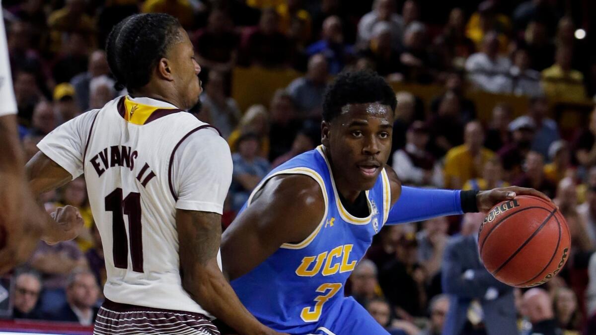 UCLA guard Aaron Holiday drives on Arizona State guard Shannon Evans II in the first half.