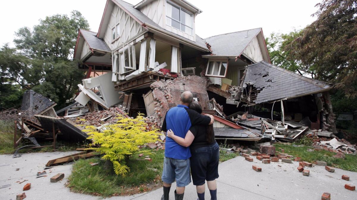 Murray and Kelly James look at their Christchurch, New Zealand, home, destroyed in an earthquake in 2011. (Mark Baker / Associated Press)