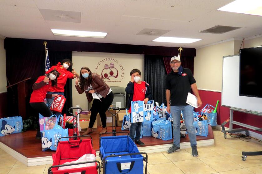 AccessCal volunteers and fellow community members sort and distribute donated toys to underserved children for Christmas.
