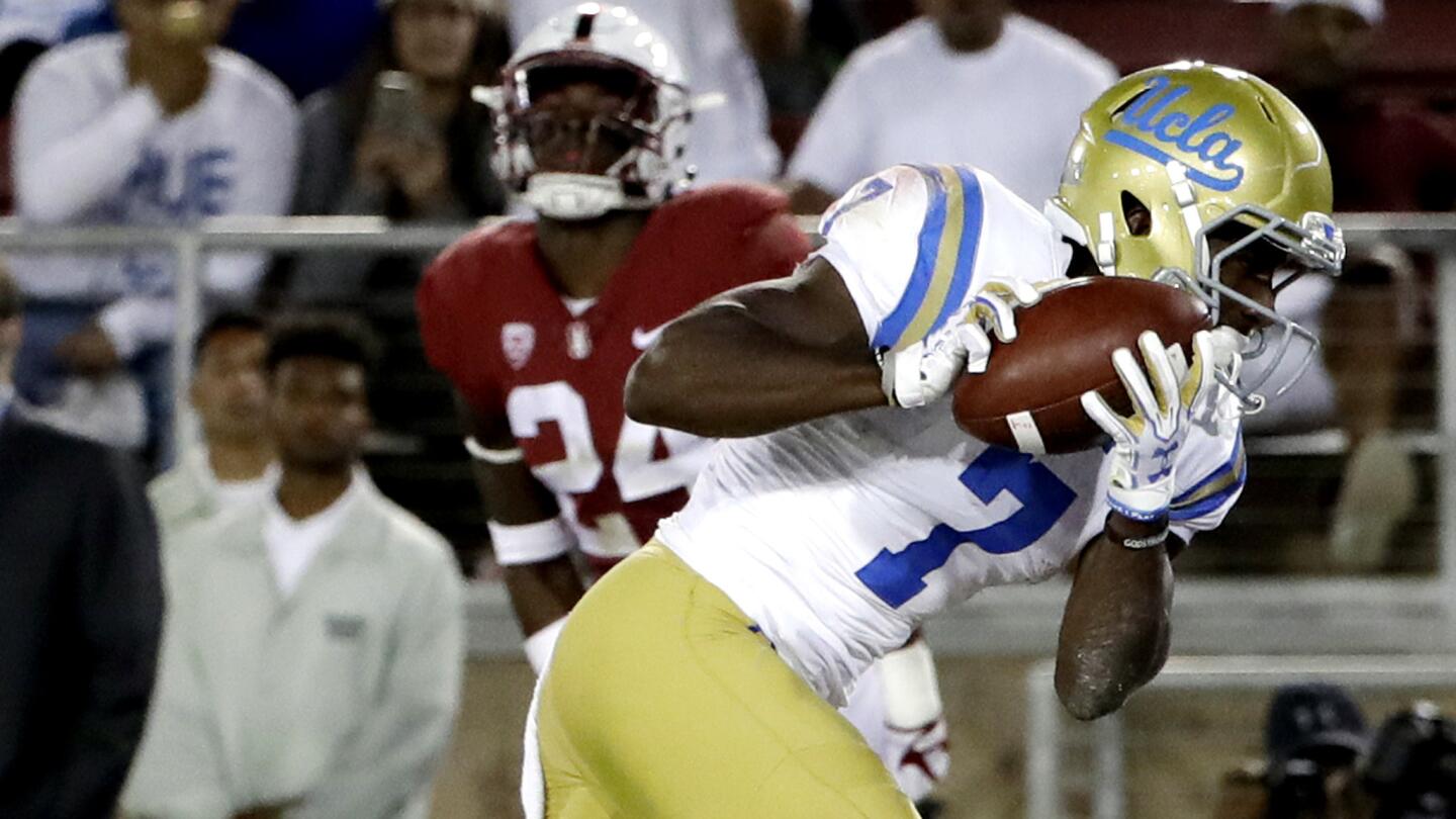 UCLA wide receiver Darren Andrews catches a touchdown pass during the first half.