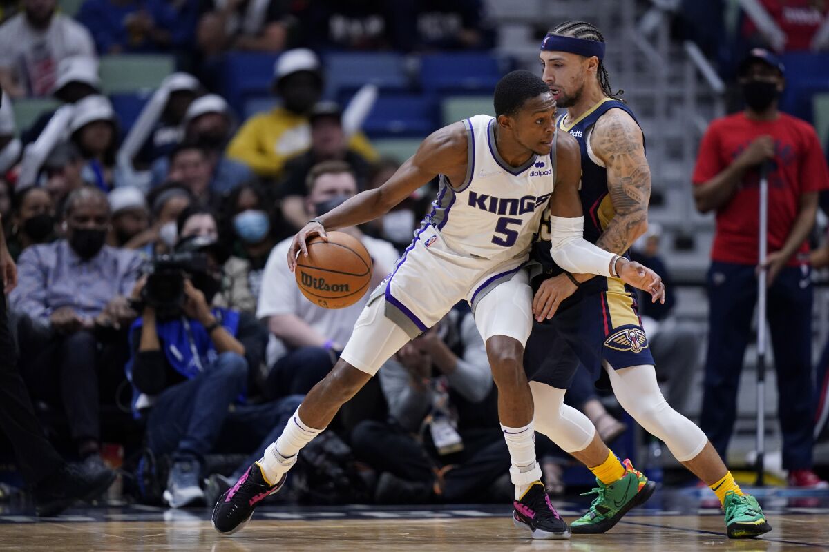 Sacramento Kings guard De'Aaron Fox (5) drives to the basket against New Orleans Pelicans guard Jose Alvarado in the second half of an NBA basketball game in New Orleans, Wednesday, March 2, 2022. The Pelicans won 125-95. (AP Photo/Gerald Herbert)