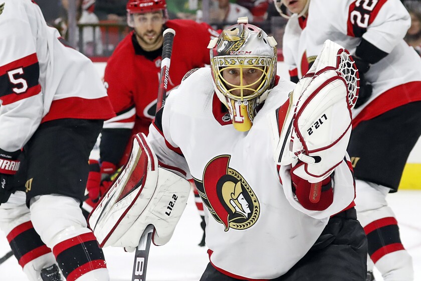 Ottawa Senators' Anton Forsberg (31) watches the puck go into his glove during the second period of the team's NHL hockey game against the Carolina Hurricanes in Raleigh, N.C., Thursday, Dec. 2, 2021. (AP Photo/Karl B DeBlaker)