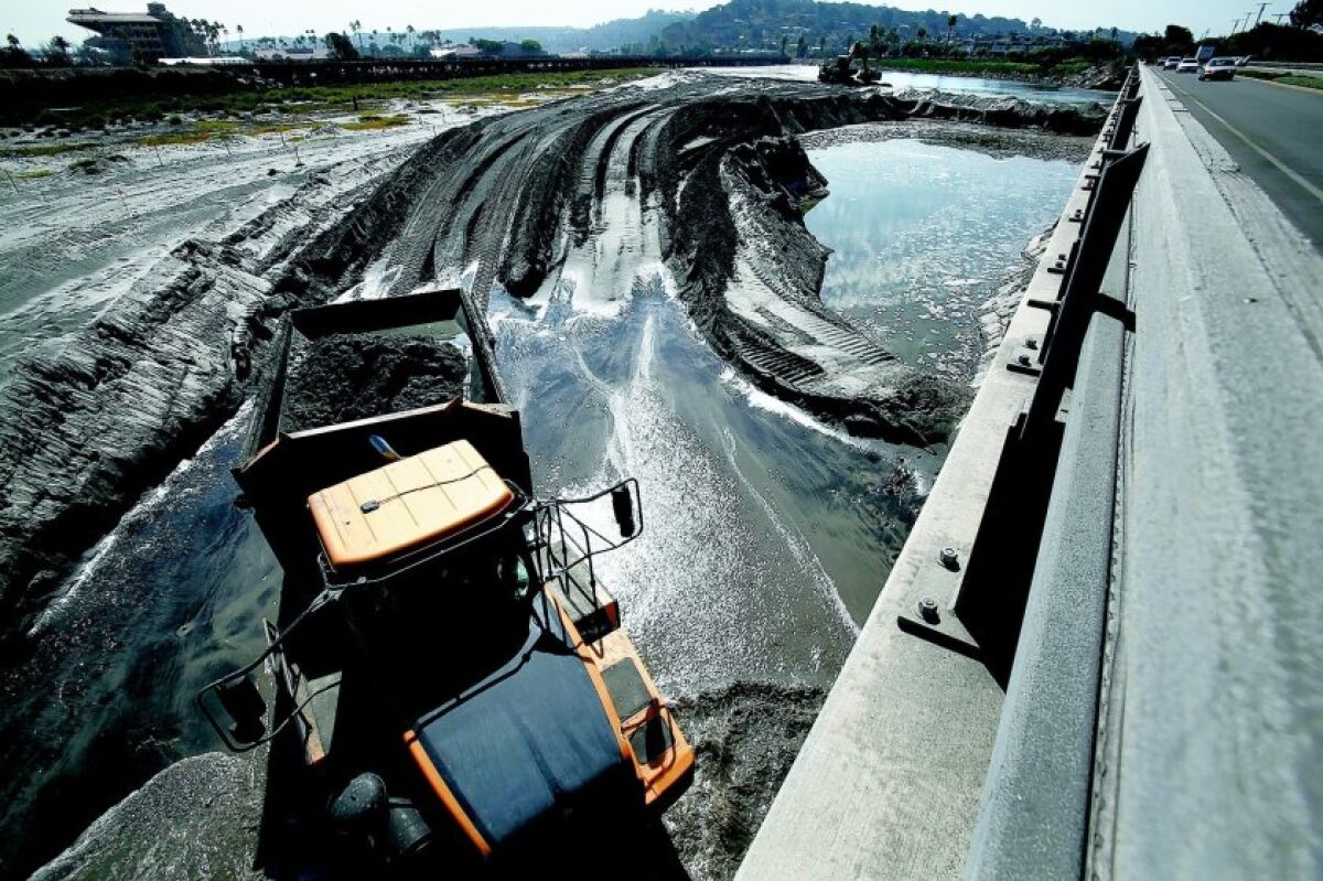 Construction crews remove sand to open the mouth of San Dieguito Lagoon in Del Mar in 2011.