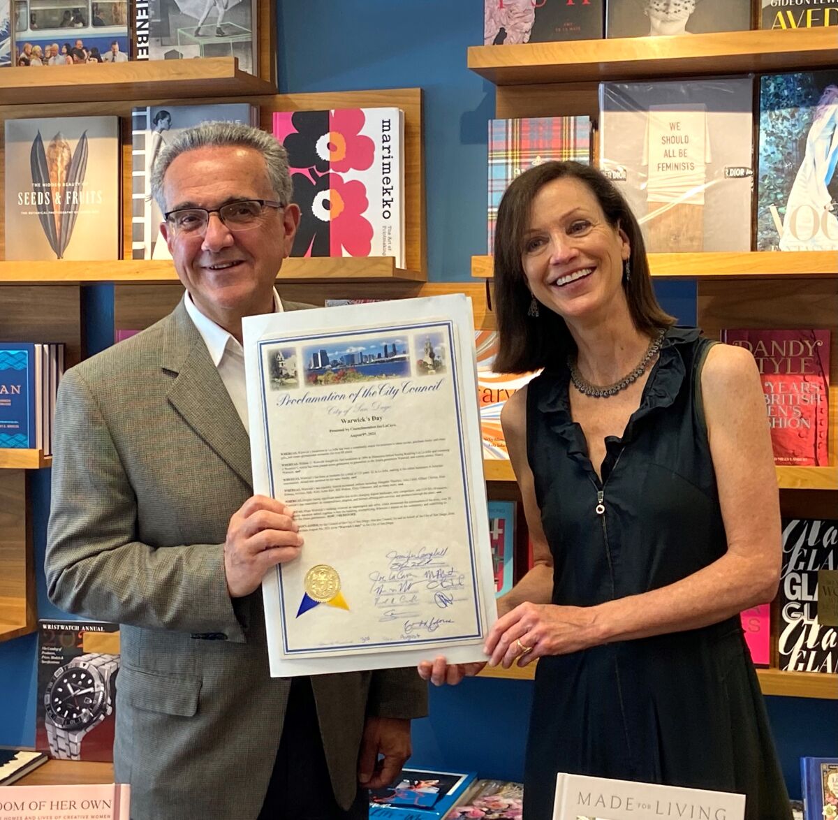 San Diego Councilman Joe LaCava gives a proclamation to Warwick's bookstore owner Nancy Warwick declaring Warwick's Day.