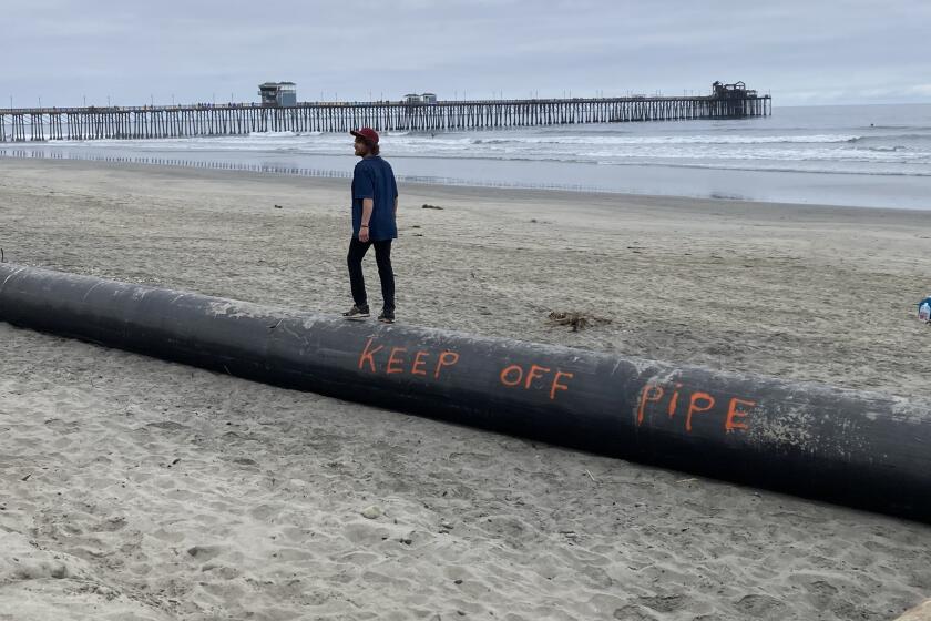 Pipes remain on the beach in Oceanside in hopes that sand replenishment will resume.