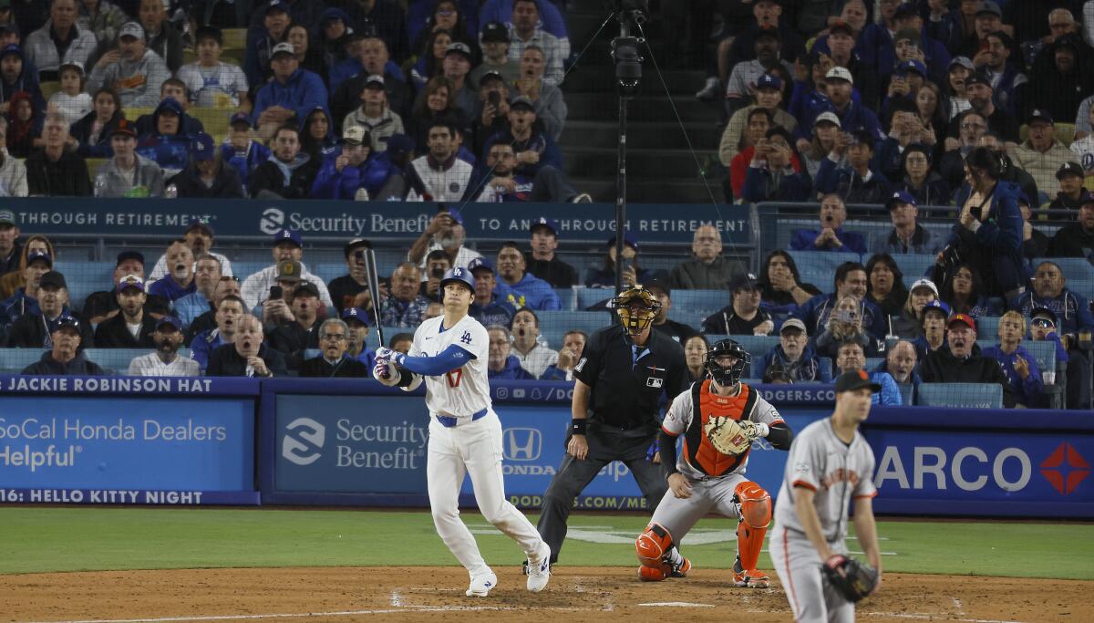 Shohei Ohtani hits his first home run as a Dodger during a game with the Giants at Dodger Stadium on April 3. 