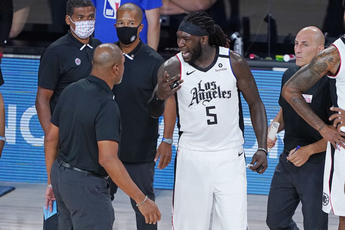 Clippers forward Montrezl Harrell talks with coach Doc Rivers during Game 3 against the Dallas Mavericks.