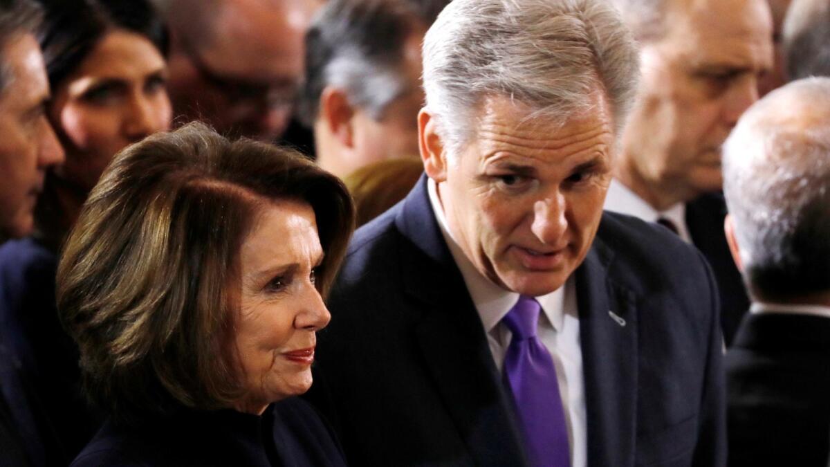 Two Californias, side by side: House Minority Leader Nancy Pelosi (D-San Francisco) chats with House Majority Leader Kevin McCarthy (R-Bakersfield) at a Capitol memorial for evangelist Billy Graham in February.