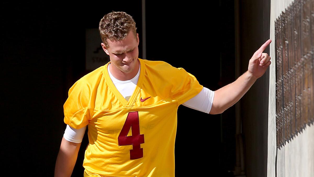 Quarterback Max Browne heads to Howard Jones Field on the USC campus for the first summer practice.