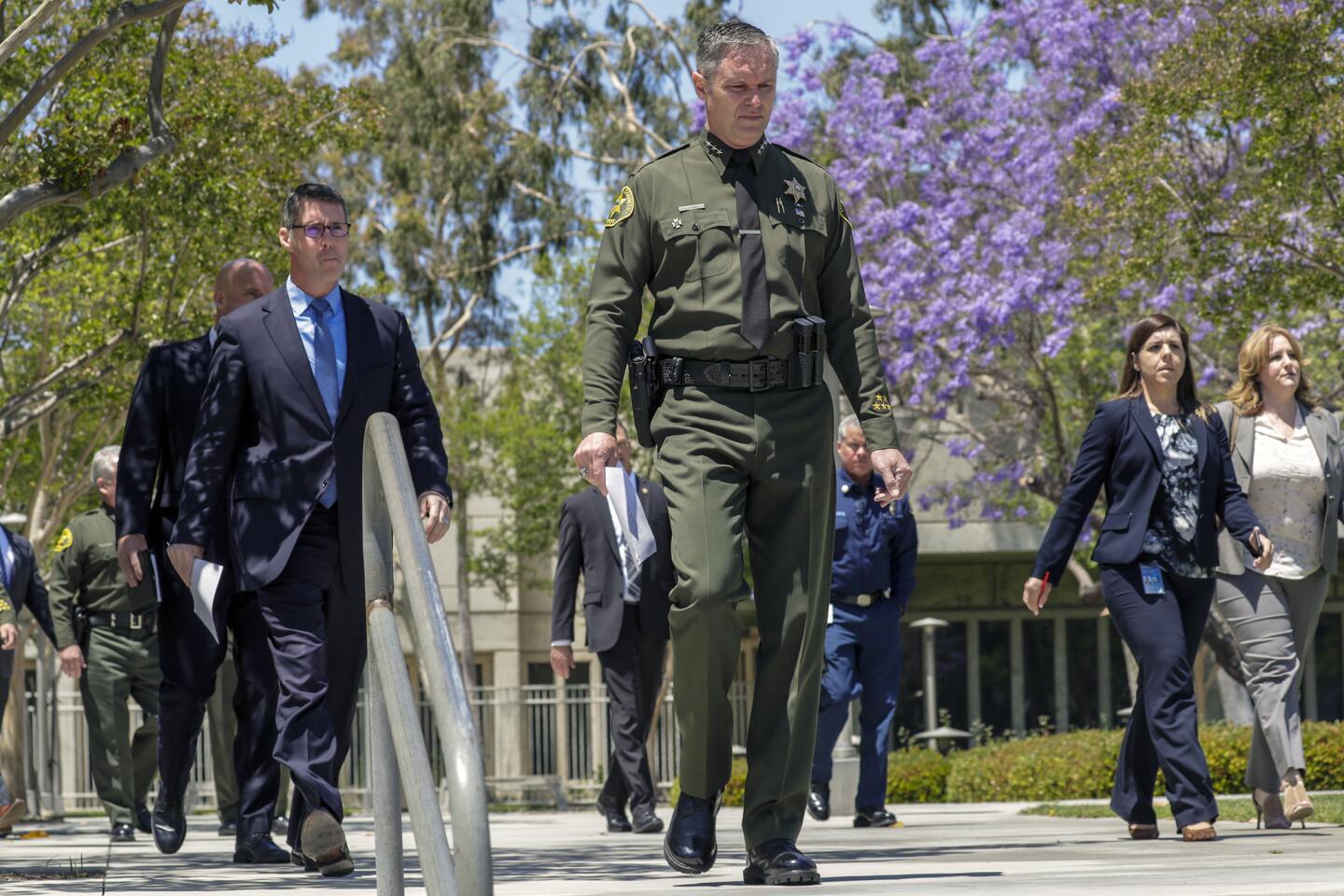 Orange County Undersheriff Don Barnes, center, and Paul Delacourt, left, assistant director of the local FBI field office, head for a news conference Wednesday to discuss Tuesday's fatal explosion in Aliso Viejo.