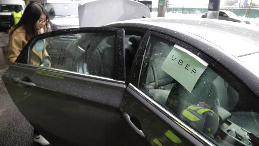 A woman gets into an Uber car in New York in 2017.