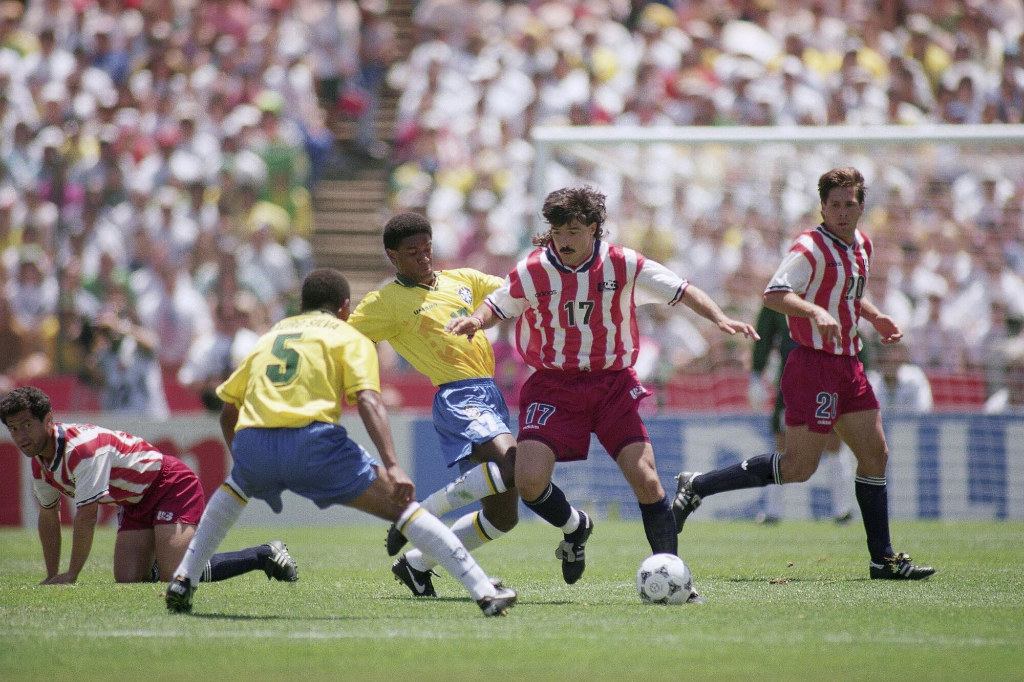 United States defender Marcelo Balboa, right, duels for the ball with Brazilians Mazinho (17).