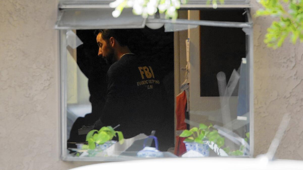 FBI agents search the Redlands home where the assailants in the San Bernardino mass shooting lived.