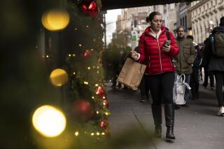 A woman carrying a shopping bag passes Macy's department store in Herald Square, Monday, Dec. 11, 2023, in New York. On Thursday, the Commerce Department releases U.S. retail sales data for November. (AP Photo/Yuki Iwamura)