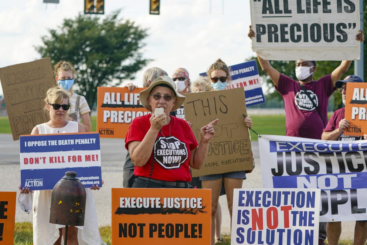 FILE - In this Wednesday, Aug. 26, 2020, file photo, Sister Barbara Battista speaks during a protest against the death penalty, across the street from the federal prison complex in Terre Haute, Ind., before the execution of Lezmond Mitchell, the only Native American on federal death row. (AP Photo/Michael Conroy, File)