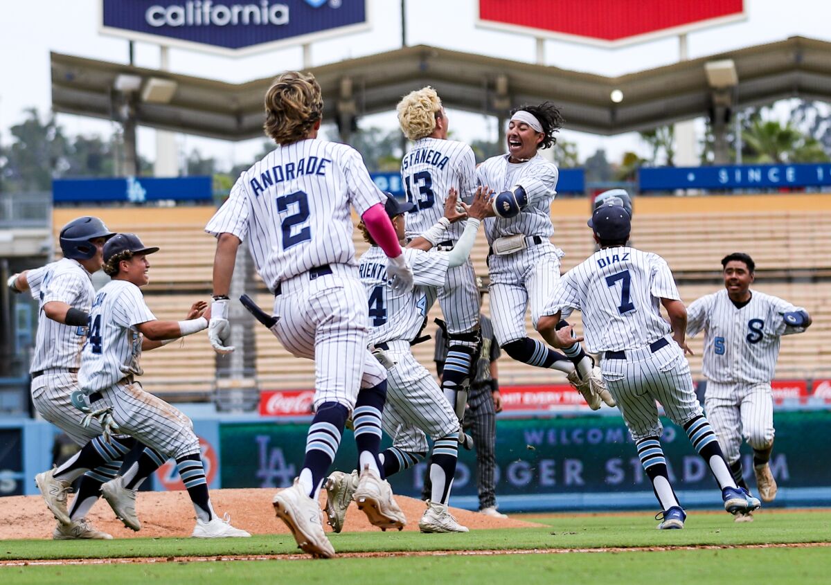 Sylmar players launch celebration after Victor Carrera's RBI single with the bases loaded in the bottom the seventh 
