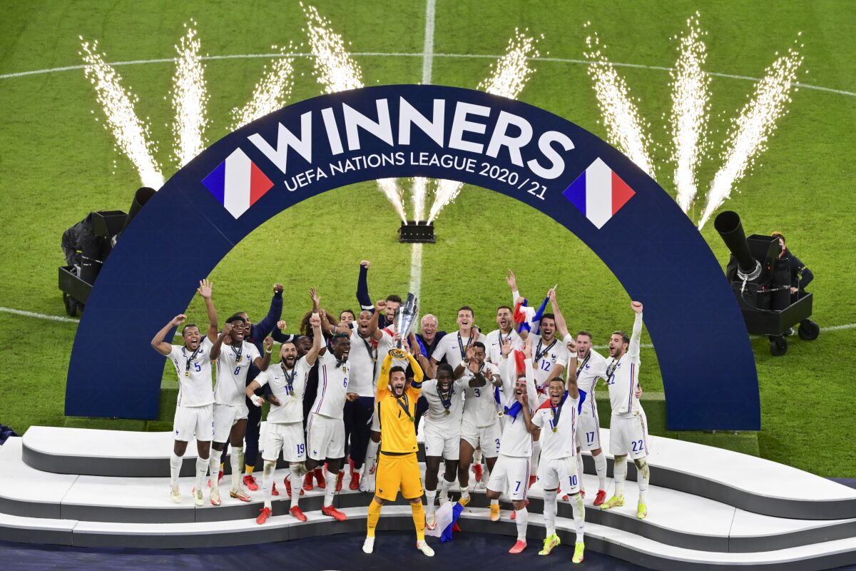 French players react with their trophy after defeating Spain to win the UEFA Nations League final soccer match at the San Siro stadium, in Milan, Italy, Sunday, Oct. 10, 2021. (Miguel Medina/Pool Photo via AP)
