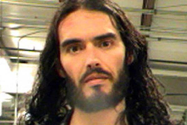 Russell Brand is in trouble again, thanks to the paparazzi. The run-in occurred in New Orleans where Brand is filming a movie. According to reports, Brand spotted a guy filming him and snatched his iPhone and tossed it through a nearby window. The police issued a warrant for criminal damage to property and Brand turned himself in. The comedian couldn't help but have a little fun with the incident, writing on Twitter, "Since Steve Jobs died I cannot bear to see anyone use an iphone irreverently. what I did was a tribute to his memory."