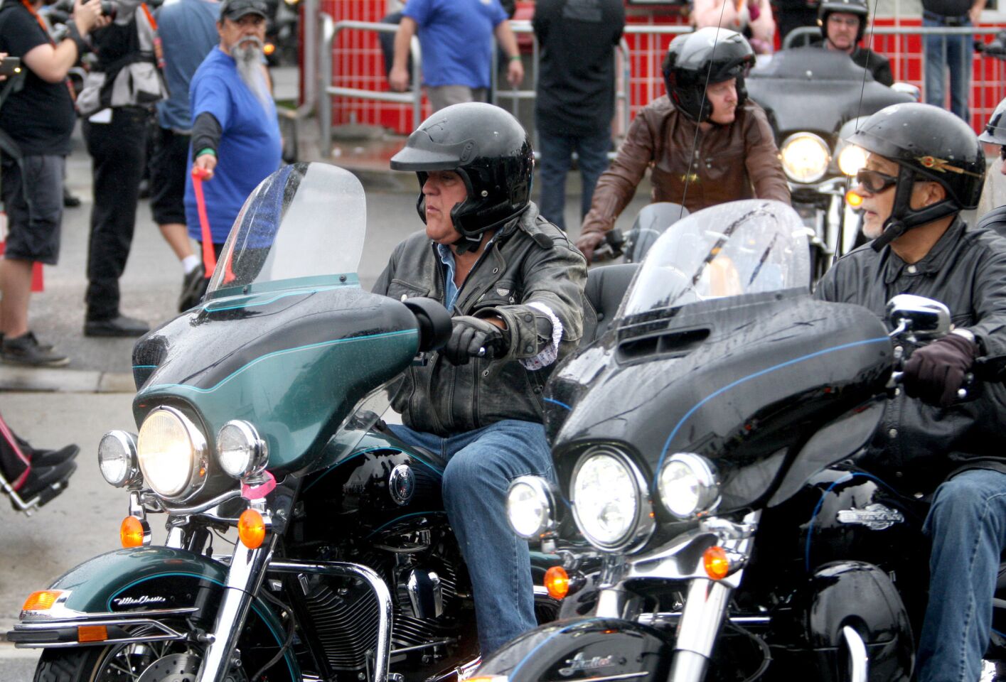 Thirty-second annual Love Ride host Jay Leno, left, rides away at the start of the event at Harley-Davidson Motorcycles in Glendale on Sunday, October 18, 2015. This will be the last fundraising Love Ride.