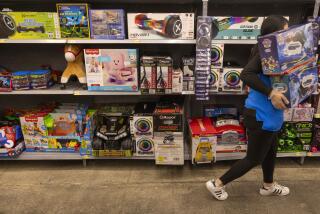 Burbank, CA - November 14: An employee stocks toy department shelves as Black Friday deals are out and prices are being rolled back at the Walmart Supercenter on Tuesday, Nov. 14, 2023 in Burbank, CA. (Brian van der Brug / Los Angeles Times)