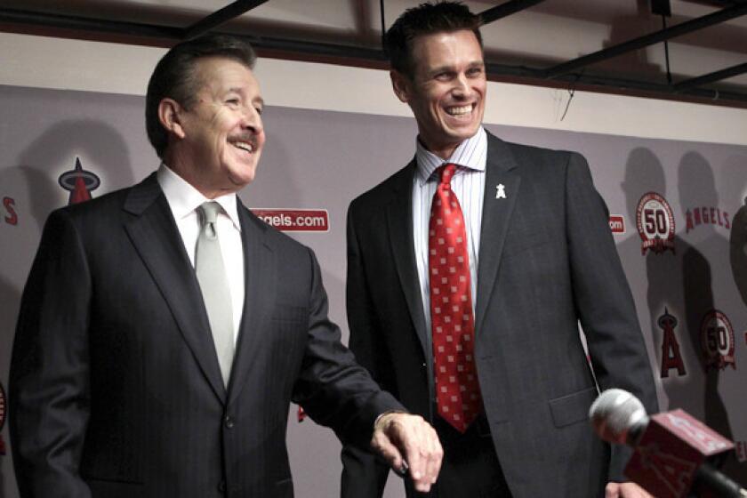 Angels General Manager Jerry Dipoto promises to aggressively rebuild the team's international scouting and development. Above, Dipoto at right with team owner Arte Moreno in 2011.