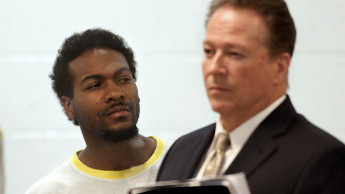 Trenton Trevon Lovell, 27, left, the suspect in the shooting death of L.A. County sheriff's deputy Steve Owen, with public defender John Henderson, during his arraignment in Lancaster.