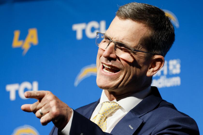 Chargers coach Jim Harbaugh speaks during his introductory press conference.