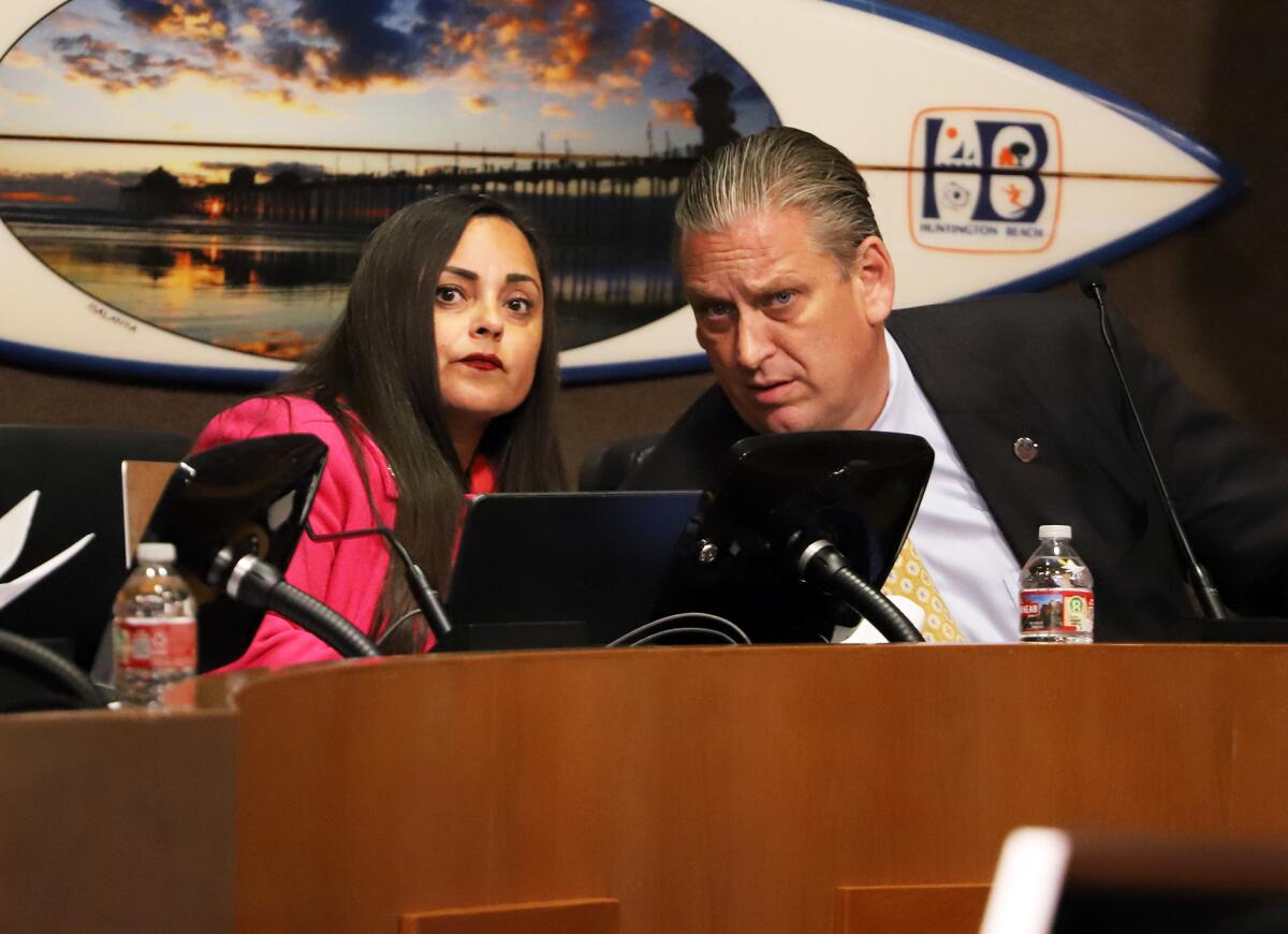 Huntington Beach Mayor Pro Tem, Gracey Van Der Mark and Mayor Tony Strickland listen to public comment during a meeting.