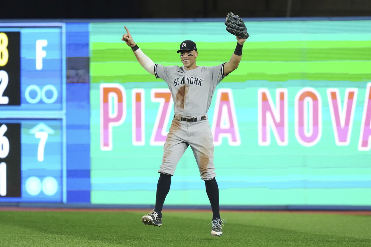 New York Yankees' Aaron Judge celebrates the team's 5-2 win over the Toronto Blue Jays in a baseball game Tuesday, Sept. 27, 2022, in Toronto. (Nathan Denette/The Canadian Press via AP)
