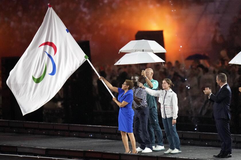 Mayor of Los Angeles Karen Bass holds the Paralympic flag during the closing ceremony.