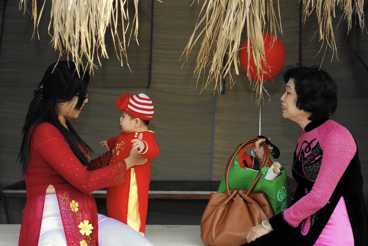 Celena Ngo, left, with son Kaycee Nguyen and mother Thanh Tran at the annual Tet Festival in Orange County.